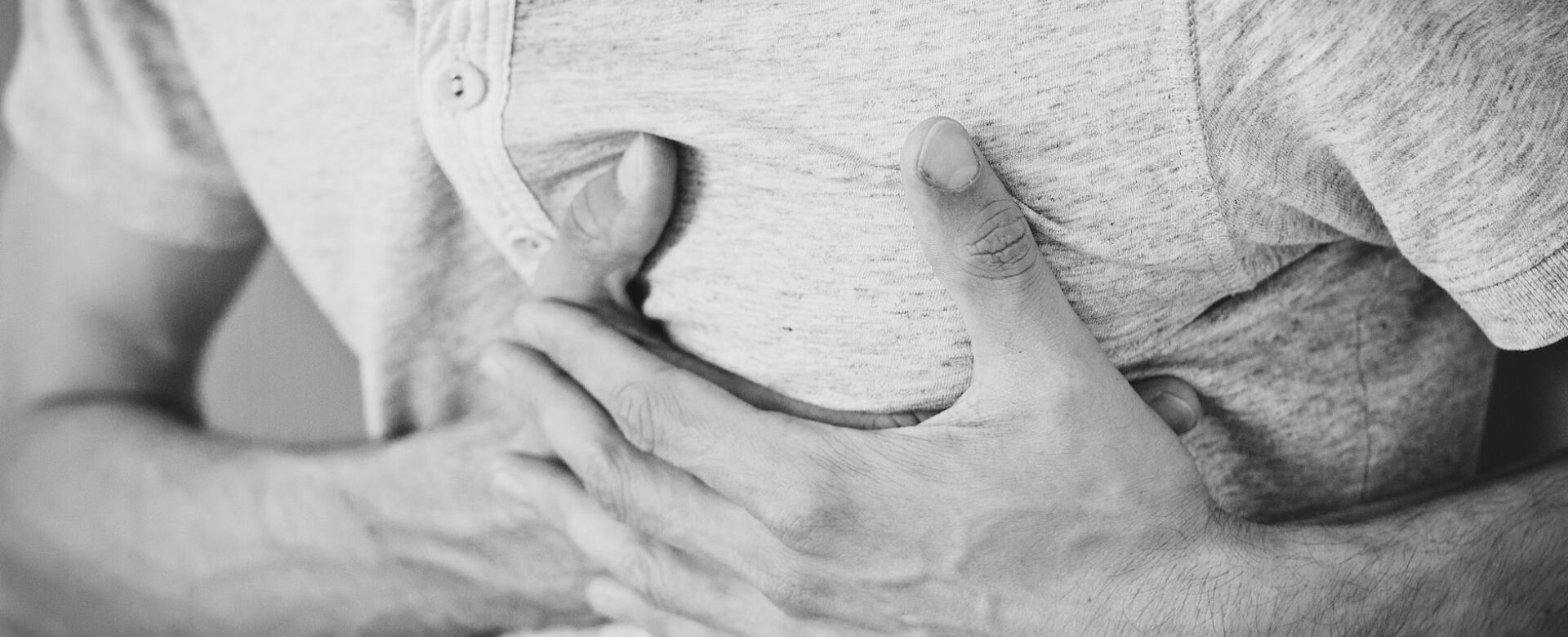 man wearing polo shirt holding left chest