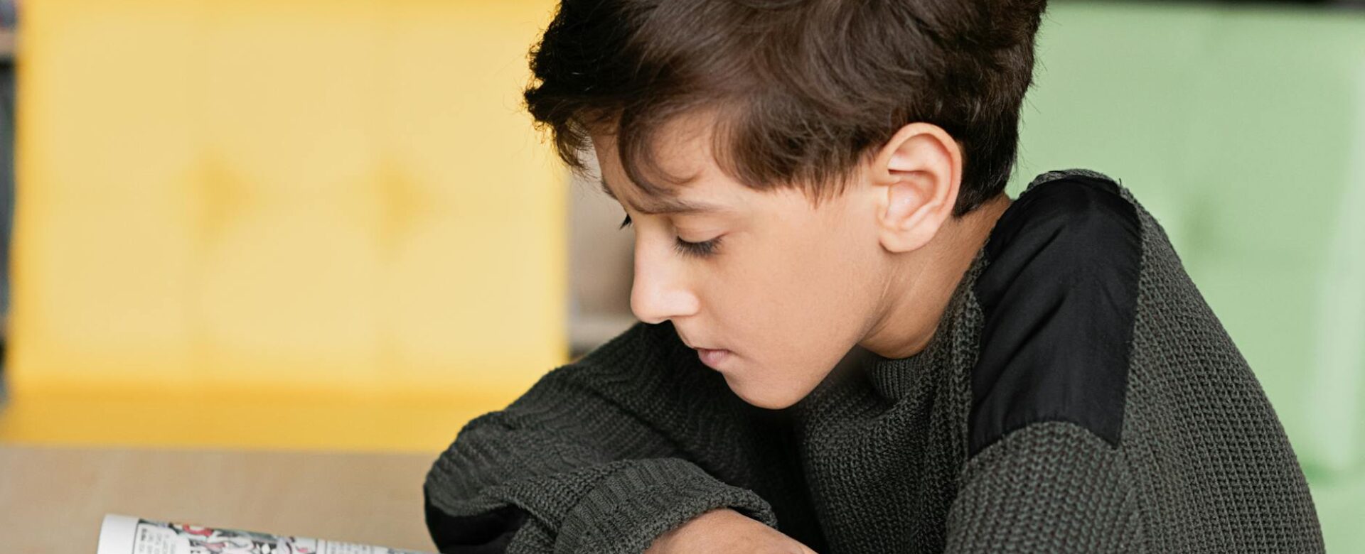 boy reading a comic book