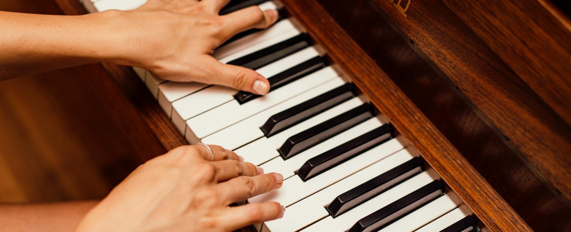 close up photo of person playing piano