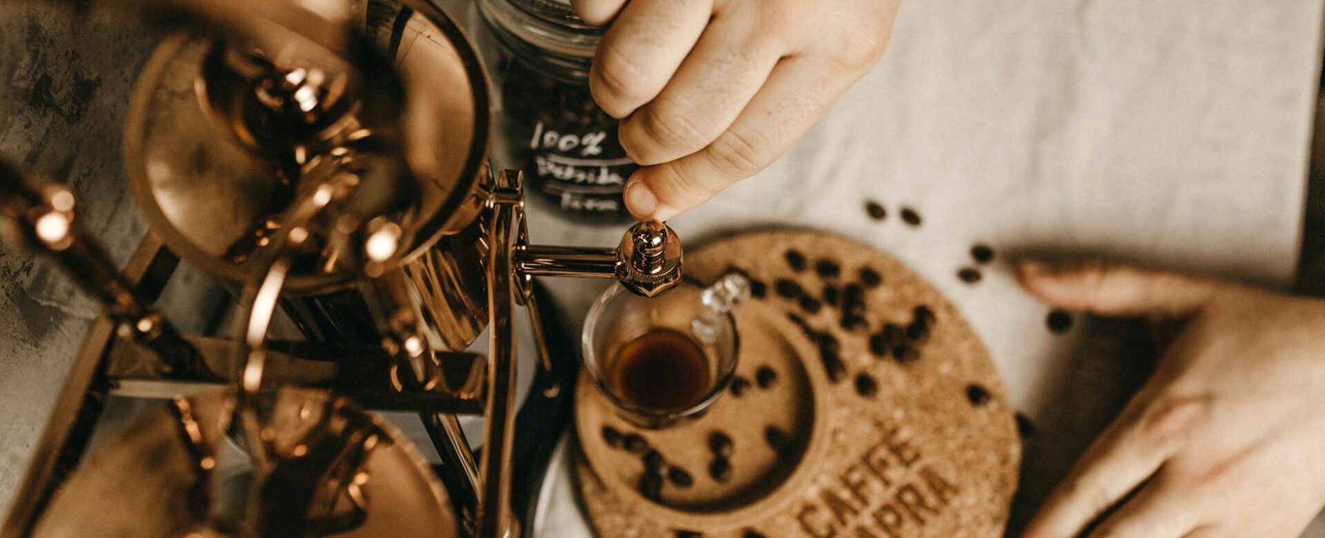hands pouring coffee into glass